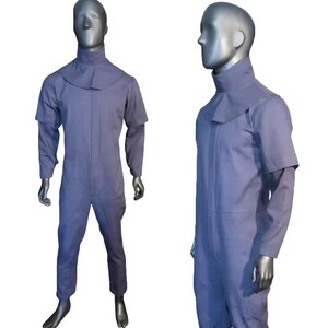 K&ouml;nnte beinhalten: Ein hellblauer Overall mit hohem Kragen und einem capeartigen Schulter&uuml;berwurf. Das Kleidungsst&uuml;ck hat lange &Auml;rmel, einen zentralen Rei&szlig;verschluss auf der Vorderseite und eine gerade geschnittene Hose, pr&auml;sentiert an einer Schaufensterpuppe.