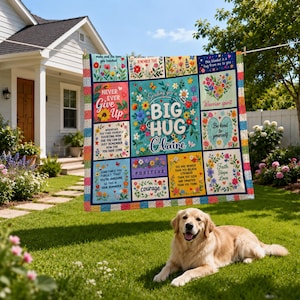 May include: A multi-colored patchwork quilt featuring floral patterns and inspirational text including 'Sending you a BIG HUG Claire', 'Never Ever Give Up', 'Warrior spirit', 'Be kind to yourself', and 'Faith Hope Love', displayed on a clothesline.