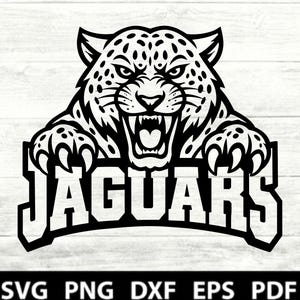 May include: A black and white graphic illustration of a snarling jaguar head with spotted fur and sharp claws, positioned above the word JAGUARS in bold, block capital letters. The bottom of the image displays the text SVG PNG DXF EPS PDF.
