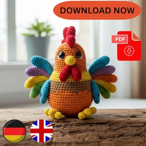 以下が含まれることがあります： オレンジ、茶色、黄色、青、緑、紫色の編みぐるみニワトリ。ニワトリは赤い鶏冠と肉垂れ、黒い目、黄色の足を持っています。画像には「DOWNLOAD NOW」というテキストとPDFアイコンが含まれています。