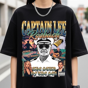 May include: Black t-shirt featuring a graphic of Captain Lee Rosbach in a captain's hat and sunglasses. The design includes text that reads "CAPTAIN LEE Rosbach" and "THE STUD OF THE SEA". Additional images and text are also present.