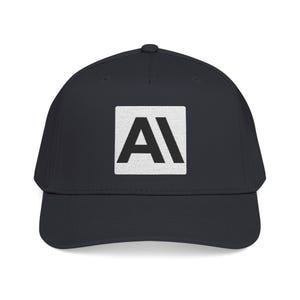 May include: A solid dark charcoal baseball cap featuring a centred white square patch. Inside the white square, the letters A and I are printed in a bold, black, sans-serif font. The cap has a structured crown and a curved brim.