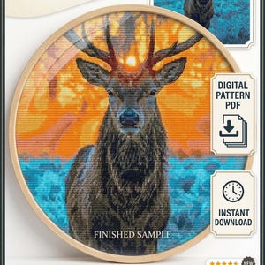 May include: A cross-stitch pattern featuring a stag with large antlers, set against a sunset backdrop of orange and blue hues. The design is framed in a wooden hoop. Text includes "Stag of Dawn and Dusk" and "Instant PDF Download".