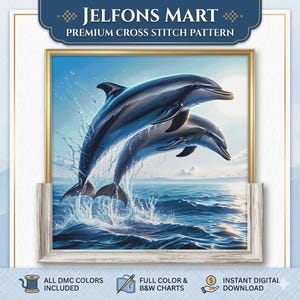 May include: A framed cross-stitch pattern featuring two dolphins leaping from the ocean. The artwork is in shades of blue and white, with water splashing around the dolphins. The frame is gold-colored, and the text "JELFONS MART PREMIUM CROSS STITCH PATTERN" is at the top.