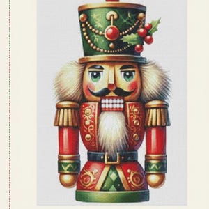 May include: Digital cross stitch pattern of a traditional Christmas nutcracker. The nutcracker is depicted in red, green, and gold, with a white beard and a stern expression. The text "Jelfons Mart" is at the top, and "Digital Cross Stitch Pattern Instant Download" is at the bottom.