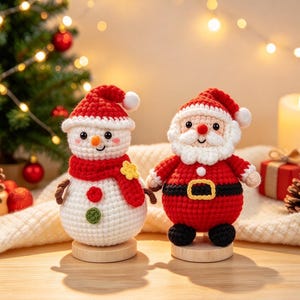 May include: Two crocheted figures standing on small wooden bases. One is a white snowman with a red scarf, hat, and buttons. The other is a Santa Claus figure in a red suit with a black belt, white beard, and red hat. Both have round bodies.