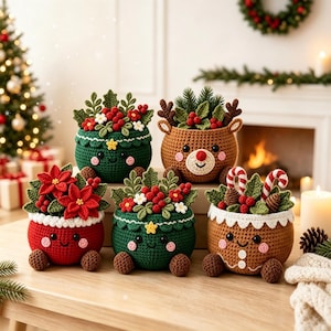 May include: Five crocheted containers with smiling faces, arranged in two rows. The containers feature festive designs including a red poinsettia pot, two green foliage pots, a brown reindeer pot with antlers, and a brown gingerbread-style pot.