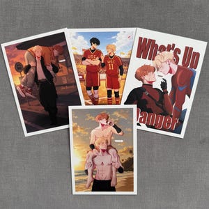 May include: Four rectangular art prints featuring anime-style illustrations of two characters. One print shows the text What's Up Danger. The scenes depict the characters in various settings, including a sunset street, a sports field, and a beach.
