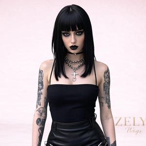 May include: A woman with black hair and bangs, wearing a black top and choker, with multiple silver necklaces and a cross pendant. The image also shows tattoos on the arms. The text "ZELYA Wigs" is visible.