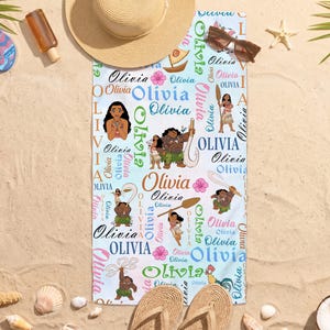 May include: A rectangular beach towel featuring a repeating pattern of the name Olivia in various fonts and colors, interspersed with illustrations of characters from the movie Moana, including Moana, Maui, Pua, and Heihei, on a light blue background.