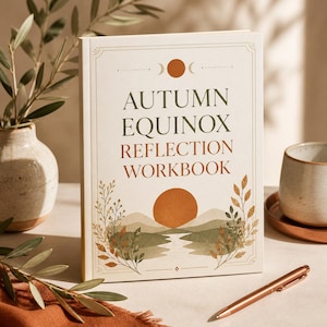 May include: A rectangular workbook with a cream cover titled Autumn Equinox Reflection Workbook in green and orange text. The cover features a central orange sun, green hills, a river, and botanical illustrations framed by thin decorative lines.
