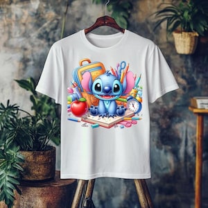 May include: White t-shirt featuring a cartoon illustration of Stitch from Lilo & Stitch. Stitch is surrounded by school supplies, including a backpack, pencils, an apple, and a clock. The design is colorful and vibrant, perfect for fans of the animated film.