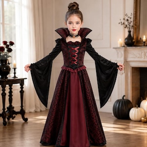 May include: A floor-length vampire costume dress featuring a high stand-up collar, long flared sleeves, and a bodice with a dark red and black damask pattern. The dress includes a solid dark red skirt panel, black velvet accents, and a lace choker.