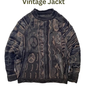 May include: A long-sleeve knit sweater featuring a dark gray and brown textured pattern with multiple peace sign symbols integrated into the design. The text "Vintage Jackt" is printed in dark green above the sweater on a white background.