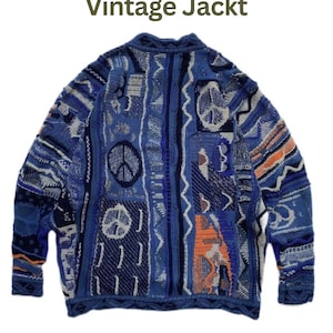 May include: A long-sleeve knit sweater featuring a complex patchwork of blue, navy, and orange geometric patterns, including multiple peace sign motifs. The text "Vintage Jackt" is printed in dark green above the garment on a white background.