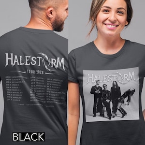 May include: A charcoal gray t-shirt featuring a black and white band photograph and the text Halestorm on the front, with a Halestorm Tour 2026 concert schedule and list of cities printed in white on the back. The shirt is labeled as black.