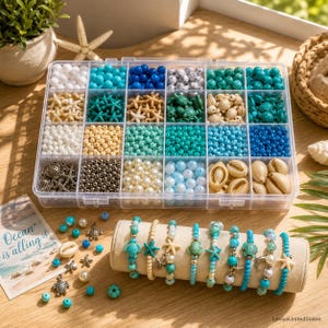 May include: A clear plastic organizer filled with various beads, shells, and charms in shades of blue, white, and beige. Several beaded bracelets with sea-themed charms are displayed on a beige stand. The text "Ocean is calling" is visible.