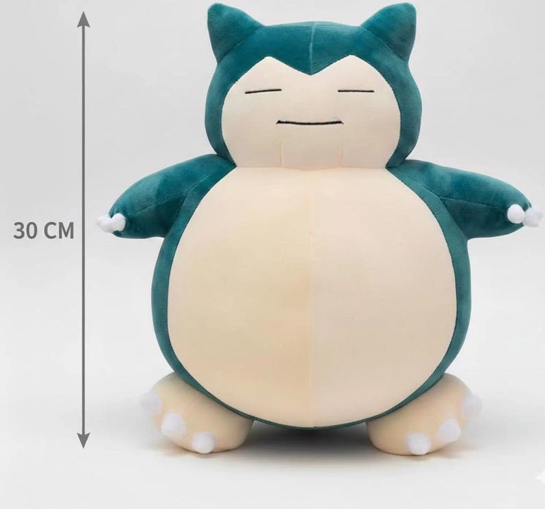 May include: A plush toy of a cartoon character, approximately 12 inches tall. The toy is teal and cream-colored, with a rounded body, small arms, and feet. It has closed eyes and a small, smiling mouth. The toy is designed to resemble a popular character.