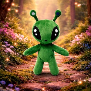 May include: A plush green alien toy with large black eyes and antennae. The alien has outstretched arms and is standing on a stone path surrounded by flowers and trees. The antennae have blue and silver accents.