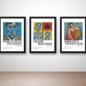 May include: Three framed art prints featuring portraits of famous artists. The first print displays a blue-toned portrait of Pablo Ruiz Picasso. The second print showcases a colorful abstract design by Henri Matisse. The third print features a portrait of Amedeo Modigliani.