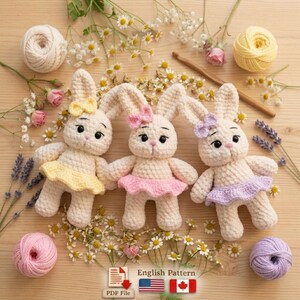 May include: Three cream-colored crochet bunny dolls with yellow, pink, and purple skirts and bows. The dolls are surrounded by yarn balls, flowers, and a crochet hook. The image includes the text "English Pattern".