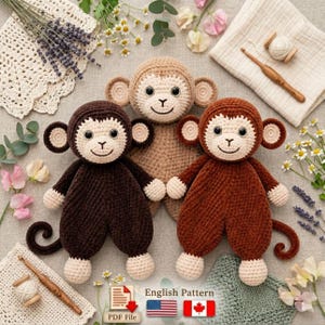 May include: Three crocheted monkey dolls in shades of brown, tan, and dark brown, each with a smiling face, large ears, and a curly tail. The dolls are handmade and appear soft. The image includes crochet supplies and the text "English Pattern".