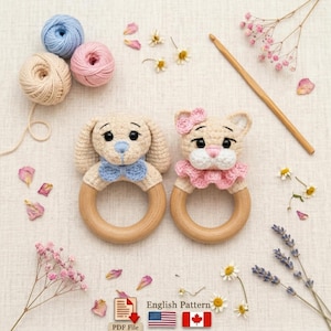 May include: Two handmade crochet baby rattles, one shaped like a puppy with a blue bow tie and the other a cat with a pink bow. Both have wooden rings. Yarn balls in beige, pink, and blue are also visible.