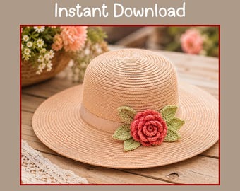 May include: A light tan straw hat featuring a wide brim and a smooth ribbon band. A crocheted pink rose with light green leaves is attached to the side of the hat. The text "Crochet Rose Pattern Pdf Instant Download" is displayed above the hat.