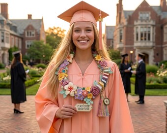 May include: A graduate in a peach-coloured cap and gown, wearing a floral lei with colourful flowers and book-shaped elements. A sign reads "Class 2026 - Vibrant Future". The background shows a university campus with brick buildings.