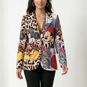 May include: A long-sleeve blazer featuring a split design with a brown and black leopard print on one side and a multi-coloured graphic print featuring Mickey Mouse on the other. The blazer is paired with solid black trousers and white trainers.