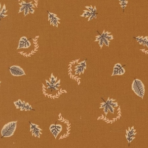 May include: A mustard yellow fabric featuring a repeating pattern of small, dark gray leaves and light cream-colored sprigs. The design consists of scattered individual leaves and pairs of leaves accompanied by curved, delicate botanical branches.