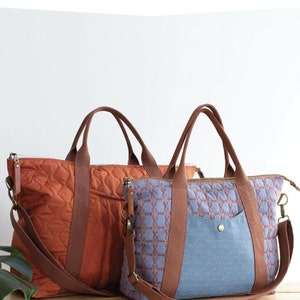 May include: Two Oxbow tote bags in different sizes, one orange and one blue, with brown straps and zippers. The bags have a quilted pattern and are displayed on a wooden surface. Text on the image reads "OXBOW TOTE" and "2 sizes to sew!"