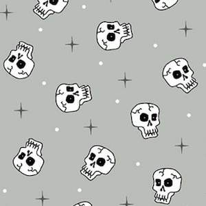 May include: A seamless pattern featuring white skulls with black eyes on a light gray background. The pattern is repeated throughout the image, with white dots and four-pointed stars scattered throughout.