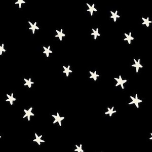 May include: Black fabric with a scattered pattern of off-white stars. The stars are hand-drawn in a whimsical style. The bottom of the image shows the text "RUBY STAR SOCIETY".