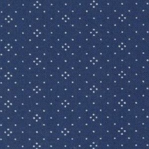 May include: A close-up of a navy blue fabric with a repeating pattern of small white floral-like shapes. The pattern is evenly spaced across the surface, creating a textured appearance. The fabric has a slightly rough texture.