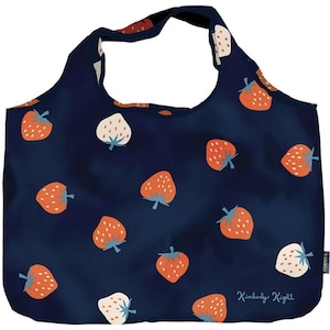 May include: A navy blue reusable shopping bag with a white and red strawberry pattern. The bag has a white label with the text "Kimberly Kight" on it.