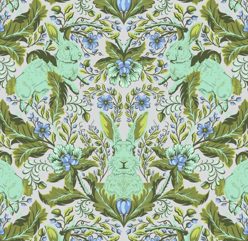 May include: A repeating pattern featuring stylized rabbits in light green, surrounded by green leaves and blue flowers on a light grey background. The design has a vintage, botanical feel, with symmetrical floral elements.