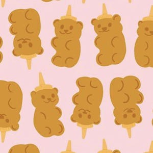 May include: A repeating pattern of brown gummy bear illustrations with a yellow honey bottle cap on their heads, set against a light pink background. The bears are on a stick.