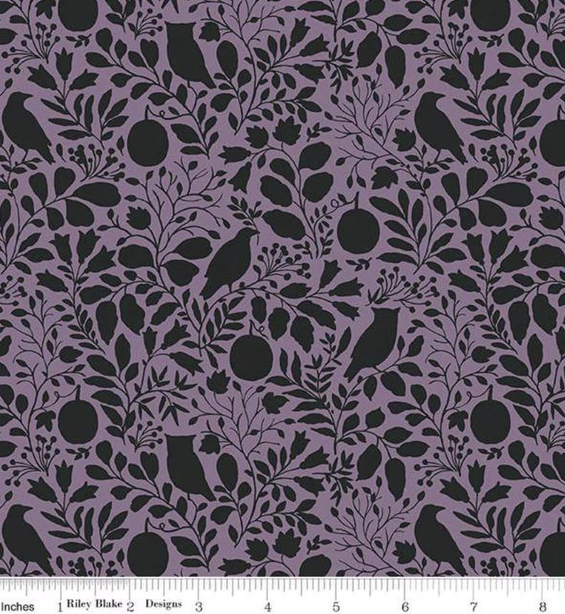 May include: A fabric with a repeating pattern of black silhouettes of birds, fruit, and foliage on a lavender background. The design includes various leaf shapes and floral elements, creating a nature-inspired aesthetic. The fabric is marked with the text "Riley Blake Designs".