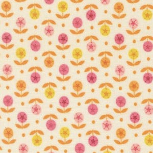May include: Cream-colored fabric with a repeating pattern of stylized flowers. The flowers are in shades of pink, yellow, and orange, with small brown dots between them. The design has a retro, whimsical feel.