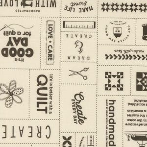May include: Beige fabric with black text and illustrations. The text includes "Create", "Handmade", "Quilt", "Love + Care", "Dream", "Good Day", "Make Life Sweet", and "It's a Good Day for a Quilt".