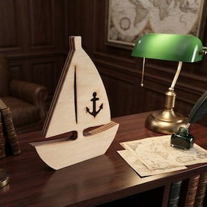 May include: A light-colored wooden sailboat cutout featuring a vertical slit for the sail and a cutout anchor symbol on the side. The object is constructed from layered wood panels, creating a distinct profile of a boat with a mast and hull.