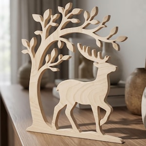 May include: A wooden deer figurine with a tree silhouette. The deer is walking, and the tree has leaves. The figurine is made of light-colored wood and is a decorative item.