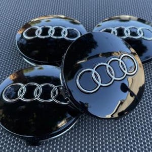 Zestaw 4 czarnych dekielków na koła 60 mm do Audi – zamiennik OEM 4B0601170-Nowość