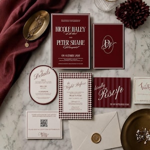 May include: A wedding stationery suite featuring deep burgundy and cream cards with white text. Includes a main invitation, a details card, a night before card with a checkered border, an RSVP card, a QR code card, and an envelope with a gold wax seal.