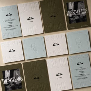 May include: A collection of wedding stationery including rectangular cards in light blue, white, and olive green. The cards feature embossed text, swan illustrations, and photographs of a couple. Text includes Details, Save the Date, RSVP, and The Sinclairs.