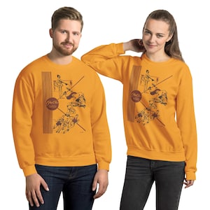May include: A mustard yellow long-sleeve crewneck sweatshirt featuring a dark brown graphic print of vintage athletes in various poses, vertical line accents, and a circular logo containing the text "Per-Che" and "All Sports Footwear".