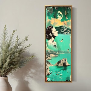 May include: Vertical framed art print with a gold frame. The artwork features a woman's profile, a full moon, seagulls, and a coastal landscape in shades of teal, green, and white. The artwork is displayed on a gray wall.