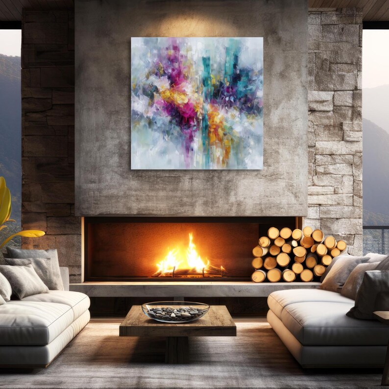May include: Abstract art painting with a vibrant mix of colors, including pink, yellow, teal, and orange. The artwork is displayed above a fireplace in a modern living room setting. The room features a neutral color palette with a cozy ambiance.