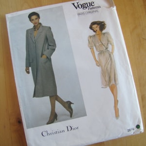 May include: Vogue Patterns Paris Original sewing pattern for a Christian Dior dress. The pattern features two illustrations of women wearing the dress, one in a gray coat and the other in a white dress. The pattern number is 2814.